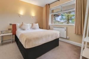 a bedroom with a large bed and a window at Killarney View House B&B in Killarney