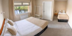 a bedroom with two beds and a window at Killarney View House B&B in Killarney +20 photos
