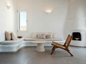 a white living room with a couch and a chair at Aqua Lumen Private Pool Villa, Mykonos in Agios Ioannis Mykonos