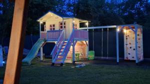 a play house with a slide in the yard at House Garden in Turda
