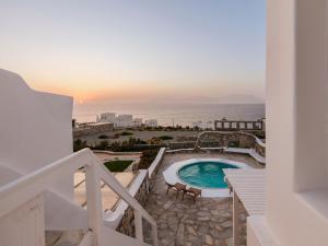 a balcony with a pool and a view of the ocean at Aqua Lumen Private Pool Villa, Mykonos in Agios Ioannis Mykonos +52 photos