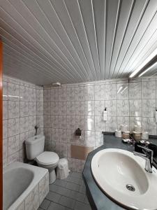 a bathroom with a sink and a toilet and a tub at Lena Apartments 4 in Potos +59 photos