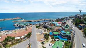 an aerial view of a town next to the ocean at Donghae Goldenview Pension in Donghae +10 photos