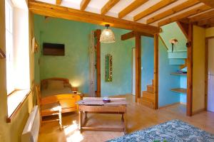 a room with a bed and a table in it at Chambres D'hôtes Dans Le Cotentin in Teurthéville-Bocage