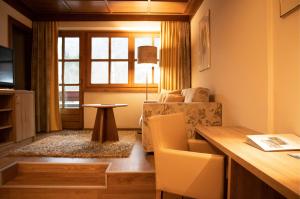 a living room with a couch and a table at Kolmhof in Bad Kleinkirchheim