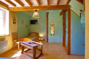 a living room with a table and a couch at Chambres D'hôtes Dans Le Cotentin in Teurthéville-Bocage