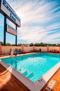 a swimming pool on the roof of a hotel at Executive Inn in Pensacola