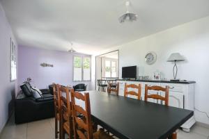 a kitchen and dining room with a table and chairs at Gîte Lilas de mer in Ponthoile +17 photos