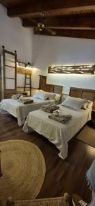 a bedroom with two beds and a rug at Cal Riol in Talarn
