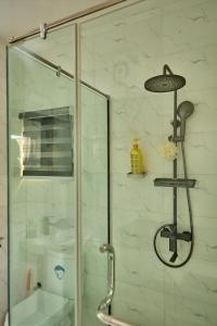 a shower with a glass door in a bathroom at Lekki Abijo Apartment in Lekki +37 photos