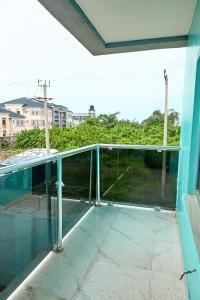 a glass balcony with a view of a yard at Lekki Abijo Apartment in Lekki