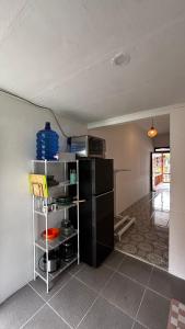 a kitchen with a black refrigerator in a room at Anugerah's House in Katiet +24 photos