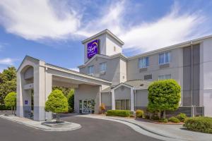 a hotel with a purple sign on top of it at Sleep Inn Garner - Clayton in Edmondson