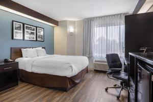 a hotel room with a bed and a desk at Sleep Inn Garner - Clayton in Edmondson