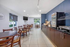 a dining room with tables and chairs in a restaurant at Sleep Inn Garner - Clayton in Edmondson