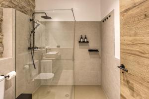 a bathroom with a shower with a glass door at El Corral in Agullana +19 photos