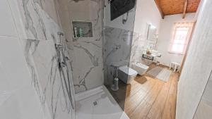 a white bathroom with a shower and a toilet at L'ALGA in Càbras +66 photos