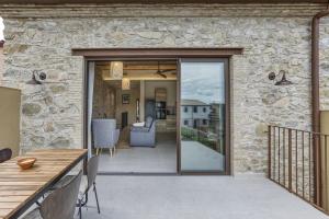 a patio with a sliding glass door leading to a deck at El Corral in Agullana