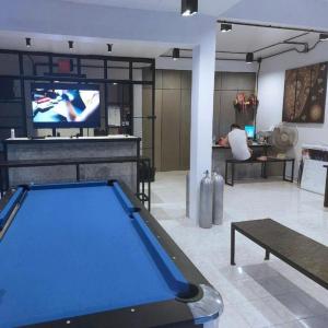a living room with a pool table and a tv at Czone Hostel in Ko Tao