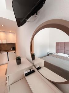 a bedroom with a bed and a mirror in a room at Lena Apartments 4 in Potos