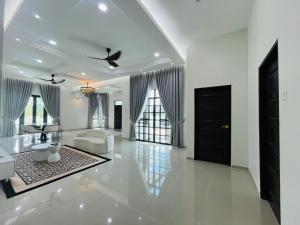 a white living room with a white couch and a black door at Husna WhiteStay Modern Luxury Family Home spacious 1700sqft Gated Parking in Bukit Payong