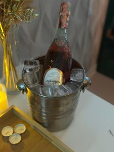 a bottle of champagne in a bucket on a table at MEIMAN hotel in Aktobe