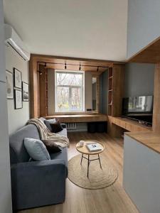a living room with a couch and a table at Cathedral Park Modern studio in Chişinău