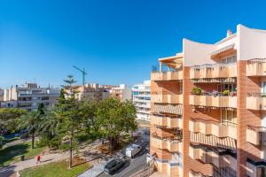 an apartment building with balconies and a street at Mar y Sol in Torrevieja