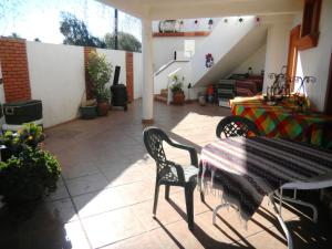 a patio with a table and chairs and stairs at Casa Lagunita in Ensenada