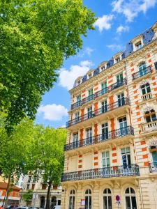 a large building with balconies on the side of it at RoomChic - Les Ambassadeurs in Vichy