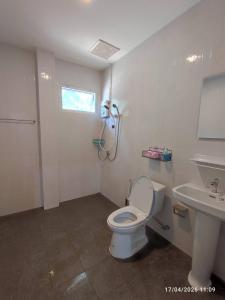 a bathroom with a white toilet and a sink at ทุ่งจับช้างโฮมสเตย์ in Pumriang +32 photos