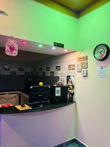 a fast food counter in a restaurant with avertisement at A2KD Stay - Achyutam Keshavam Krishna Damodaram in Tiruvannāmalai