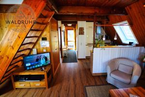 a living room with a staircase in a tiny house at Waldruhe 37 inkl Bettwäsche und Handtücher, schlüsselloser Self-Check-in in Bad Arolsen