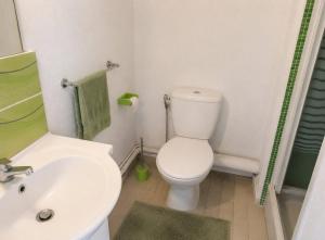 a bathroom with a white toilet and a sink at El Rivet - appartement vue mer avec parking in Sète