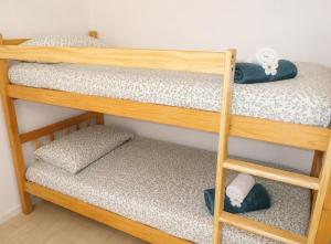 a couple of bunk beds with towels on them at El Rivet - appartement vue mer avec parking in Sète