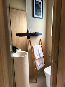 a bathroom with a sink and a toilet and a towel at NOMAD Chic Private Pool Loft in Canggu, all inclusive stay in Dalung +17 photos