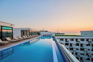 a swimming pool on the roof of a building at CosTan Apartment Infinity Spa & Parking in Mamaia Sat/Năvodari