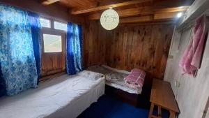 a small room with a bed and a window at Mount Mahabharat Homestay in Panaoti