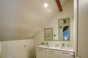 a bathroom with two sinks and two mirrors at Chambres D'hôtes Dans Le Cotentin in Teurthéville-Bocage +49 photos