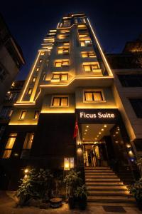 a lit up building with a flinders shuttle sign on it at Ficus Suites in Hanoi