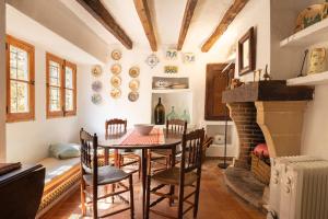 a dining room with a table and a fireplace at Finca Es Coste by Rentallorca in Pollença