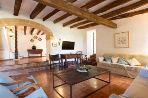 a living room with a couch and a table at Finca Es Coste by Rentallorca in Pollença
