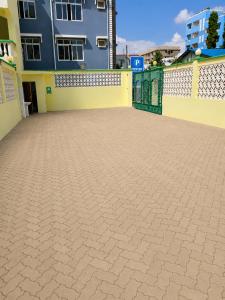an empty parking lot in front of a building at Prestige Leisure Hotel in Mtwapa