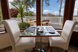 a dining room with a table and chairs and a window at Killarney View House B&B in Killarney
