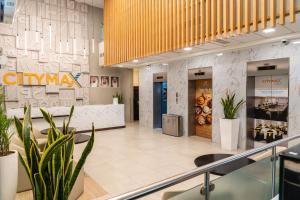 a lobby of a store with potted plants at Citymax Sharjah in Sharjah