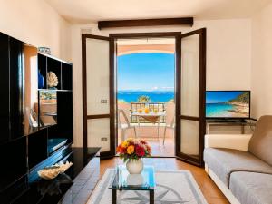 a living room with a view of the ocean at Baja Sardinia Sea View And Pool B in Baja Sardinia