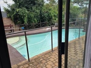 a swimming pool seen through a window at Witteberg in Krugersdorp