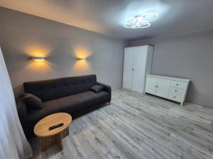 a living room with a couch and a table at 2-room apartment with separate rooms in Narva