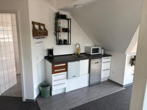 a kitchen with a sink and a microwave at Appartement am Peterstor in Montabaur