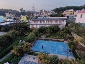 an overhead view of a tennis court in a city at The Doghouse in Dehradun